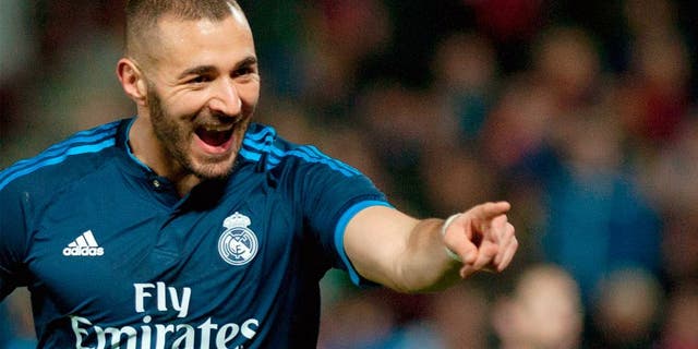 Real Madrid's French forward Karim Benzema celebrates a goal during the Spanish league football match Granada FC vs Real Madrid CF at Nuevo Los Carmenes stadium in Granada on February 7, 2016. AFP PHOTO / JORGE GUERRERO / AFP / Jorge Guerrero (Photo credit should read JORGE GUERRERO/AFP/Getty Images)