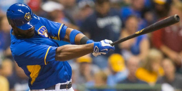 Sep 23, 2016; Milwaukee, WI, USA; Milwaukee Brewers first baseman Chris Carter (33) hits a home run during the second inning against the Cincinnati Reds at Miller Park. Mandatory Credit: Jeff Hanisch-USA TODAY Sports