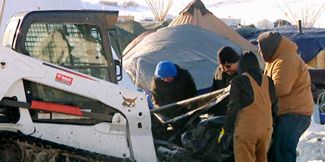 This Monday, Jan. 30, 2017, photo from video provided by KXMB in Bismarck, N.D., shows cleanup beginning at a North Dakota encampment near Cannon Ball where Dakota Access oil pipeline opponents have protested for months.