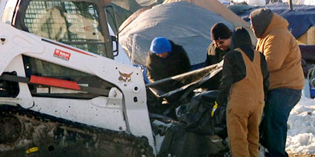 This Monday, Jan. 30, 2017, photo from video provided by KXMB in Bismarck, N.D., shows cleanup beginning at a North Dakota encampment near Cannon Ball where Dakota Access oil pipeline opponents have protested for months.