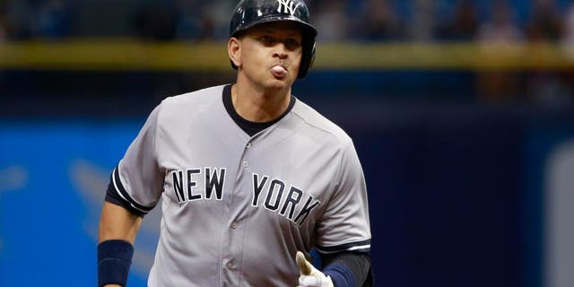 Sep 15, 2015; St. Petersburg, FL, USA; New York Yankees designated hitter Alex Rodriguez (13) hits a solo home run during the first inning against the Tampa Bay Rays at Tropicana Field. Mandatory Credit: Kim Klement-USA TODAY Sports