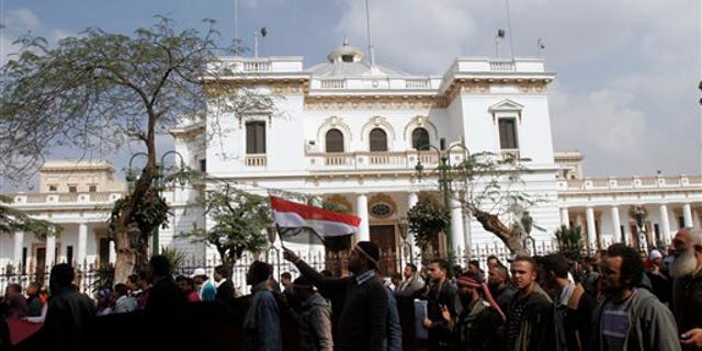 Feb. 9: Protesters wave Egyptian flags in front of the Egyptian Parliament in Cairo, Egypt. Around 2,000 protesters waved huge flags outside the parliament, located several blocks from Tahrir Square, where they moved a day earlier in the movement's first expansion out of the square. They chanted slogans demanding the dissolving of the legislature, where almost all the seats are held by the ruling party. (AP)