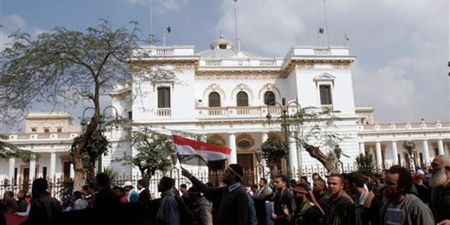 Feb. 9: Protesters wave Egyptian flags in front of the Egyptian Parliament in Cairo, Egypt. Around 2,000 protesters waved huge flags outside the parliament, located several blocks from Tahrir Square, where they moved a day earlier in the movement's first expansion out of the square. They chanted slogans demanding the dissolving of the legislature, where almost all the seats are held by the ruling party. (AP)