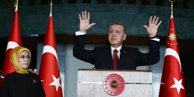 Feb. 9, 2016: Turkish President Recep Tayyip Erdogan, right, addresses a reception next to his wife Emine Erdogan at his palace in Ankara, Turkey.