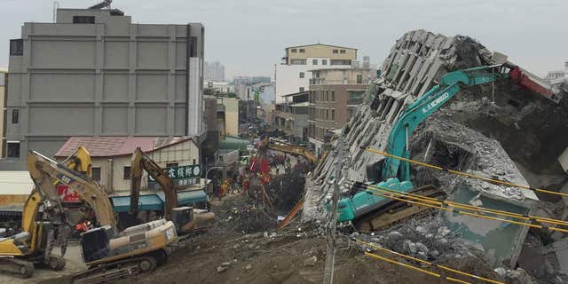 Feb. 10, 2016: Rescue workers using excavators continue to search the rubble of a collapsed building complex in Tainan, Taiwan.