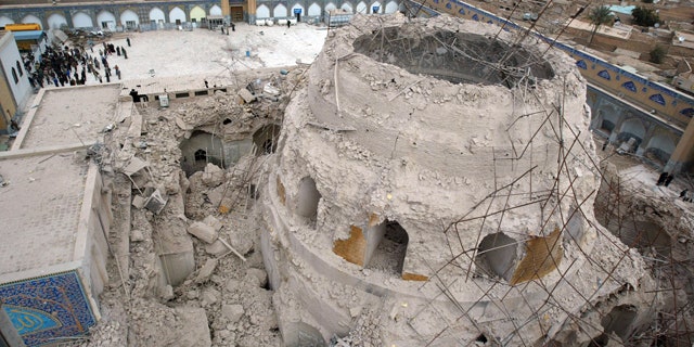 FILE - In this Feb. 22, 2006 file photo, Iraqis gather at the ruins of the al-Askari mosque in Samarra, Iraq.