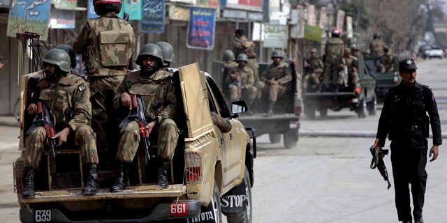 Feb. 10: Pakistan army soldiers patrol in the vicinity of the army training camp in Mardan near Peshawar, Pakistan.