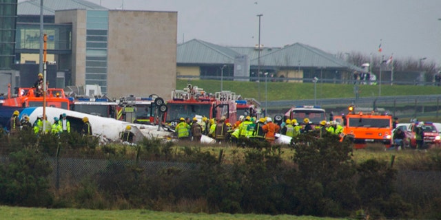 Feb. 10: Emergency services attend the scene after a small commuter aircraft carrying 12 people crashed as it tried to land in heavy fog at Cork Airport in southwest Ireland.