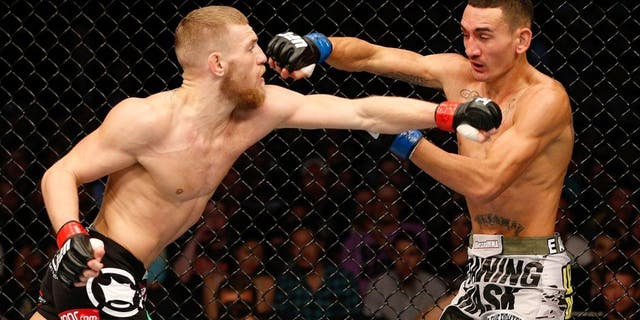 BOSTON, MA - AUGUST 17: (L-R) Conor McGregor punches Max Holloway in their UFC featherweight bout at TD Garden on August 17, 2013 in Boston, Massachusetts. (Photo by Josh Hedges/Zuffa LLC/Zuffa LLC via Getty Images)