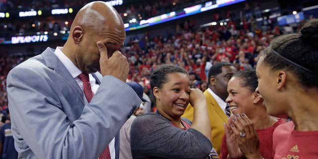 FILE - In this April 15, 2015, file photo, New Orleans Pelicans coach Monty Williams reacts after the team's victory in an NBA basketball game against the San Antonio Spurs in New Orleans. Williams' wife, Ingrid Williams, is second from right.