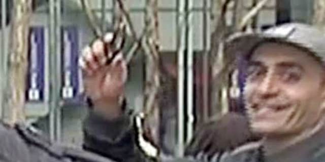 Feb. 10, 2016: In this image taken from WNBC-TV video, a man appears to wave a handgun behind a television news reporter during a live broadcast in New York City