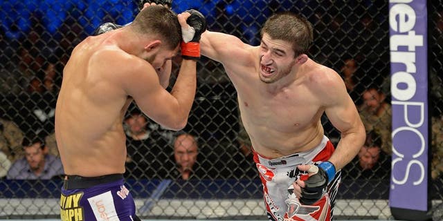 FORT CAMPBELL, KENTUCKY - NOVEMBER 6: (R-L) Rustam Khabilov punches Jorge Masvidal in their UFC lightweight bout on November 6, 2013 in Fort Campbell, Kentucky. (Photo by Jeff Bottari/Zuffa LLC/Zuffa LLC via Getty Images)
