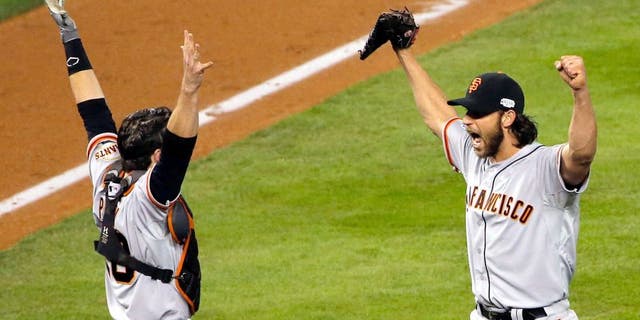 KANSAS CITY, MO - OCTOBER 29: Buster Posey #28 and Madison Bumgarner #40 of the San Francisco Giants celebrate after defeating the Kansas City Royals to win Game Seven of the 2014 World Series by a score of 3-2 at Kauffman Stadium on October 29, 2014 in Kansas City, Missouri. (Photo by Doug Pensinger/Getty Images)