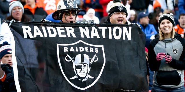 DENVER, CO - DECEMBER 13: Oakland Raiders fans cheer as their team leads the Denver Broncos at Sports Authority Field at Mile High on December 13, 2015 in Denver, Colorado. (Photo by Doug Pensinger/Getty Images)