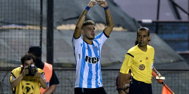 Argentina's Racing Club forward Gustavo Bou (C) celebrates after scoring a goal against Mexico's Puebla during the Copa Libertadores 2016 football match at Juan Domingo Peron stadium in Avellaneda, Buenos Aires, Argentina, on February 10, 2016. AFP PHOTO / JUAN MABROMATA / AFP / JUAN MABROMATA (Photo credit should read JUAN MABROMATA/AFP/Getty Images)