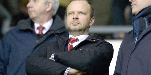 Manchester United's executive vice-chairman Ed Woodward (C) stands in the crowd ahead of the FA cup fourth round football match between Derby County and Manchester United at Pride Park stadium in Derby on January 29, 2016. / AFP / OLI SCARFF / RESTRICTED TO EDITORIAL USE. No use with unauthorized audio, video, data, fixture lists, club/league logos or 'live' services. Online in-match use limited to 75 images, no video emulation. No use in betting, games or single club/league/player publications. / (Photo credit should read OLI SCARFF/AFP/Getty Images)