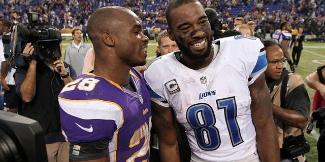 Nov 11, 2012; Minneapolis, MN, USA; Detroit Lions wide receiver Calvin Johnson (81) talks with Minnesota Vikings running back Adrian Peterson (28) following the game at the Metrodome. The Vikings defeated the Lions 34-24. Mandatory Credit: Brace Hemmelgarn-USA TODAY Sports