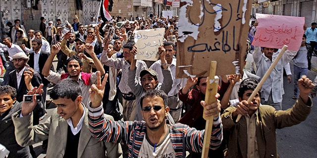 Feb. 12: Yemeni anti-government demonstrators chant slogans and hold banners during a demonstration celebrating the resignation of Egyptian leader Hosni Mubarak and demanding the ouster of their own president, in Sanaa, Yemen.