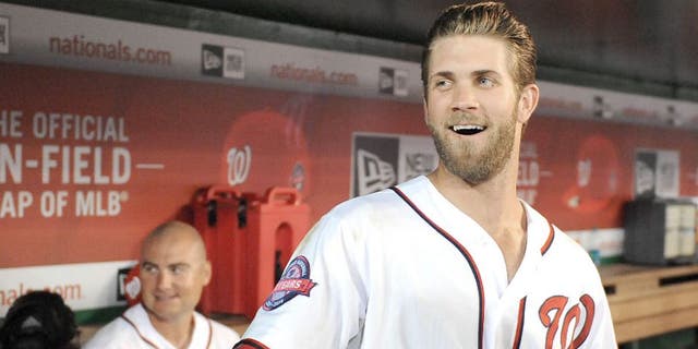 Apr 23, 2015; Washington, DC, USA; Washington Nationals right fielder Bryce Harper (34) jokes with fans during a delay in the game between the Washington Nationals and the Los Angeles Dodgers at Nationals Park. Mandatory Credit: Brad Mills-USA TODAY Sports