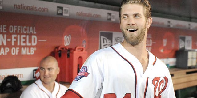 Apr 23, 2015; Washington, DC, USA; Washington Nationals right fielder Bryce Harper (34) jokes with fans during a delay in the game between the Washington Nationals and the Los Angeles Dodgers at Nationals Park. Mandatory Credit: Brad Mills-USA TODAY Sports