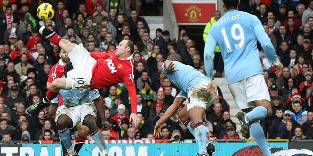 MANCHESTER, ENGLAND - FEBRUARY 12: Wayne Rooney of Manchester United scores their second goal during the Barclays Premier League match between Manchester United and Manchester City at Old Trafford on February 12, 2011 in Manchester, England. (Photo by Matthew Peters/Man Utd via Getty Images) *** Local Caption *** Wayne Rooney