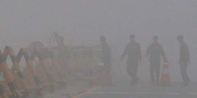 Feb. 12, 2016: South Korean Army soldiers walk on a foggy and rainy morning at Unification Bridge near the border village of Panmunjom in Paju, South Korea.