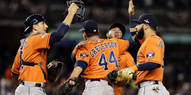 Oct 6, 2015; Bronx, NY, USA; Houston Astros relief pitcher Luke Gregerson (44) celebrates with teammates after defeating the New York Yankees in the American League Wild Card playoff baseball game at Yankee Stadium. Houston won 3-0. Mandatory Credit: Adam Hunger-USA TODAY Sports