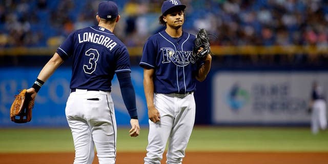 ST. PETERSBURG, FL - OCTOBER 3: Third baseman Evan Longoria #3 of the Tampa Bay Rays comes out to the mound to speak to pitcher Chris Archer #22 of the Tampa Bay Rays after Jose Bautista #19 of the Toronto Blue Jays hit an RBI single to score Cliff Pennington #9 during the third inning of a game on October 3, 2015 at Tropicana Field in St. Petersburg, Florida. (Photo by Brian Blanco/Getty Images)