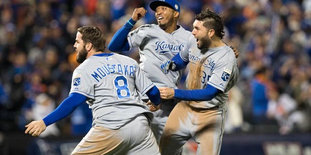 NEW YORK, NY - NOVEMBER 1: Mike Moustakas #8, Eric Hosmer #35 and Alcides Escobar #2 of the Kansas City Royals celebrate on the field after defeating the New York Mets in Game 5 of the 2015 World Series at Citi Field on Sunday, November 1, 2015 in the Queens borough of New York City. (Photo by Rob Tringali/MLB Photos via Getty Images)