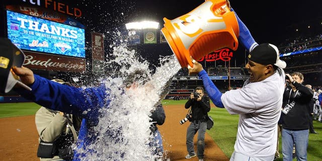 NEW YORK, NY - NOVEMBER 01: Salvador Perez #13 of the Kansas City Royals douses manager Ned Yost #3 of the Kansas City Royals after defeating the New York Mets in Game Five of the 2015 World Series at Citi Field on November 1, 2015 in the Flushing neighborhood of the Queens borough of New York City. The Kansas City Royals defeated the New York Mets with a score of 7 to 2 to win the World Series. (Photo by Al Bello/Getty Images)