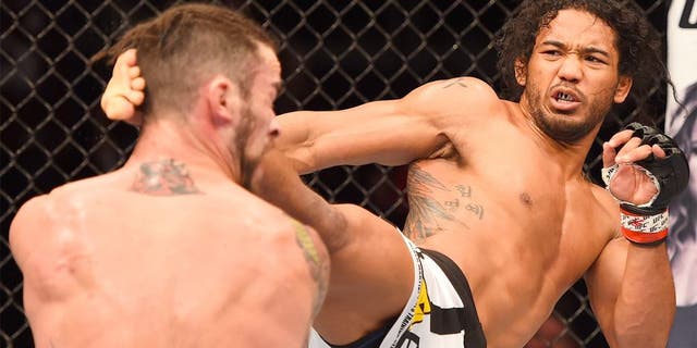 BROOMFIELD, CO - FEBRUARY 14: (R-L) Benson Henderson lands a kick to the head of Brandon Thatch in their welterweight fight during the UFC Fight Night event inside 1stBank Center on February 14, 2015 in Broomfield, Colorado. (Photo by Josh Hedges/Zuffa LLC/Zuffa LLC via Getty Images)