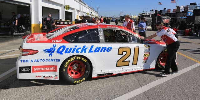 DAYTONA BEACH, FL - FEBRUARY 13: The car of Ryan Blaney (not pictured), driver of the #21 Motorcraft/Quick Lane Tire &amp; Auto Center Ford, is pushed by crew members through the garage area during practice for the NASCAR Sprint Cup Series Daytona 500 at Daytona International Speedway on February 13, 2016 in Daytona Beach, Florida. (Photo by Jerry Markland/Getty Images)