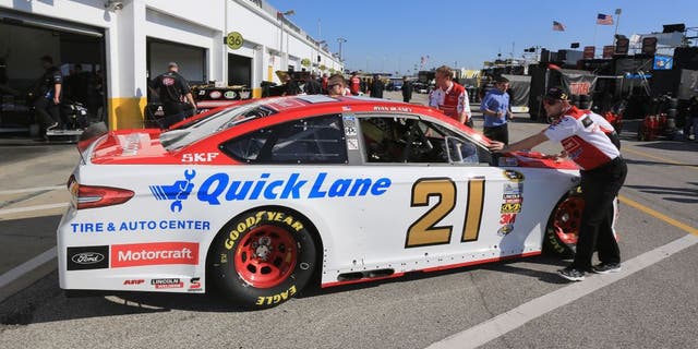 DAYTONA BEACH, FL - FEBRUARY 13: The car of Ryan Blaney (not pictured), driver of the #21 Motorcraft/Quick Lane Tire & Auto Center Ford, is pushed by crew members through the garage area during practice for the NASCAR Sprint Cup Series Daytona 500 at Daytona International Speedway on February 13, 2016 in Daytona Beach, Florida. (Photo by Jerry Markland/Getty Images)