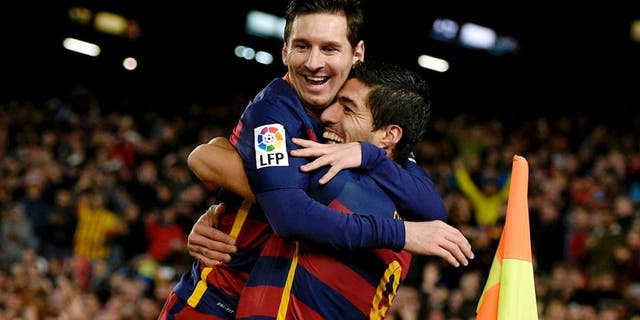 Barcelona's Uruguayan forward Luis Suarez (R) celebrates a goal with Barcelona's Argentinian forward Lionel Messi (C) and Barcelona's Brazilian defender Dani Alves during the Spanish league football match FC Barcelona vs RC Celta de Vigo at the Camp Nou stadium in Barcelona on February 14, 2016. / AFP / LLUIS GENE (Photo credit should read LLUIS GENE/AFP/Getty Images)