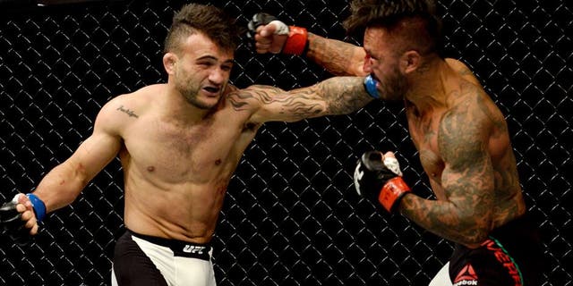 LAS VEGAS, NV - SEPTEMBER 05: (L-R) John Lineker punches Francisco Rivera in their bantamweight bout during the UFC 191 event inside MGM Grand Garden Arena on September 5, 2015 in Las Vegas, Nevada. (Photo by Brandon Magnus/Zuffa LLC/Zuffa LLC via Getty Images)