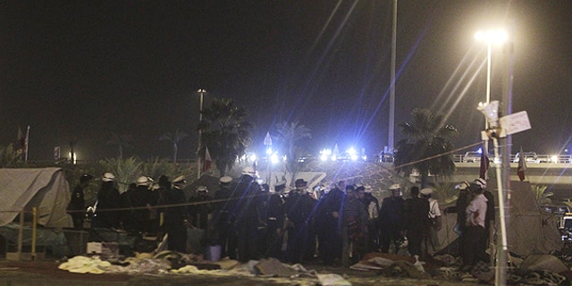 Feb. 17: Bahrani riot policemen are seen after attacking peaceful demonstrators camping at the Pearl roundabout, in Manama, Bahrain.