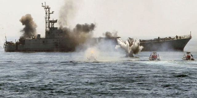 April 22, 2010: An Iranian warship and speed boats take part in a naval war game in the Persian Gulf and the Strait of Hormuz, southern Iran. (Reuters)