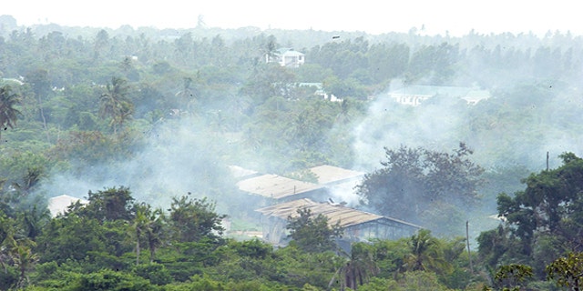 Feb. 17: Smoke drifts over the Gongolamboto military camp on the outskirts of Dar es Salaam following several explosions.