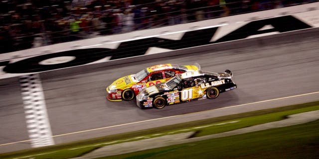 DAYTONA, FL - FEBRUARY 18: Kevin Harvick, driver of the #29 Shell/Pennzoil Chevrolet, leads Mark Martin, driver of the #01 U.S. ARMY Chevrolet, to the finish line to win the NASCAR Nextel Cup Series Daytona 500 at Daytona International Speedway on February 18, 2007 in Daytona, Florida. (Photo by Chris McGrath/Getty Images for NASCAR) *** Local Caption *** Kevin Harvick;Mark Martin