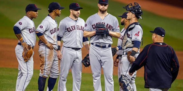 Sep 23, 2015; Minneapolis, MN, USA; Cleveland Indians shortstop Jose Ramirez (11) and shortstop Francisco Lindor (12) and second baseman Jason Kipnis (22) and first baseman Carlos Santana (41) and catcher Yan Gomes (10) wait with starting pitcher Corey Kluber (28) as manager Terry Francona comes to remove him from the game with the Minnesota Twins in the fourth inning at Target Field. Mandatory Credit: Bruce Kluckhohn-USA TODAY Sports