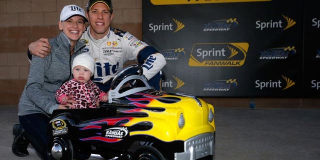 KANSAS CITY, KS - OCTOBER 16: Brad Keselowski, driver of the #2 Miller Lite Ford, poses with his girlfriend Paige White and their daughter Scarlett after Keselowski qualified on the pole for the NASCAR Sprint Cup Series Hollywood Casino 400 at Kansas Speedway on October 16, 2015 in Kansas City, Kansas. (Photo by Brian Lawdermilk/NASCAR via Getty Images)