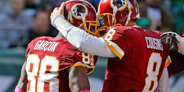EAST RUTHERFORD, NJ - OCTOBER 18: Pierre Garcon #88 of the Washington Redskins is congratulated by his teammate Kirk Cousins #8 after scoring a first quarter touchdown at MetLife Stadium on October 18, 2015 in East Rutherford, New Jersey. (Photo by Alex Goodlett/Getty Images)