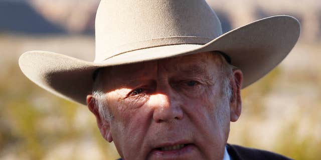 FILE - In a Wednesday, Jan. 27, 2016 file photo, rancher Cliven Bundy speaks to media while standing along the road near his ranch, in Bunkerville, Nev.