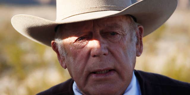 FILE - In a Wednesday, Jan. 27, 2016 file photo, rancher Cliven Bundy speaks to media while standing along the road near his ranch, in Bunkerville, Nev.