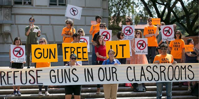 FILE - In this Oct. 1, 2015, file photo, protesters gather on the West Mall of the University of Texas campus to oppose a new state law that expands the rights of concealed handgun license holders to carry their weapons on public college campuses.