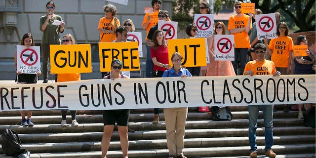 FILE - In this Oct. 1, 2015, file photo, protesters gather on the West Mall of the University of Texas campus to oppose a new state law that expands the rights of concealed handgun license holders to carry their weapons on public college campuses.
