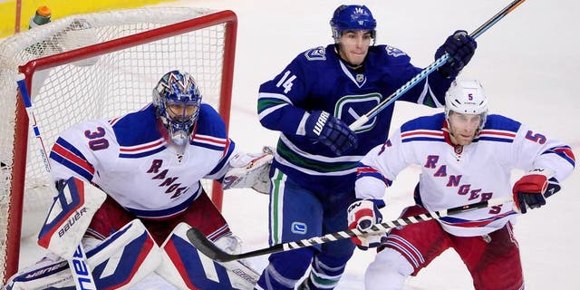 Dec 13, 2014; Vancouver, British Columbia, CAN; Vancouver Canucks forward Alexandre Burrows (14) gets between New York Rangers goaltender Henrik Lundqvist (30) and defenseman Dan Girardi (5) during the third period at Rogers Arena. The New York Rangers won 5-1. Mandatory Credit: Anne-Marie Sorvin-USA TODAY Sports