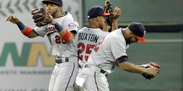 HOUSTON, TX - SEPTEMBER 5: (L TO R) Eddie Rosario, Byron Buxton, and Miguel Sano celebrate the Minnesota Twins' 3-2 victory over the Houston Astros at Minute Maid Park on September 5, 2015 in Houston, Texas. (Photo by Eric Christian Smith/Getty Images)