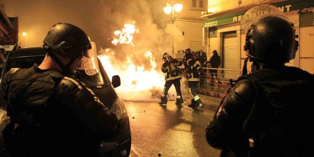 Firefighters try to extinguish a fire during clashes between protesters and police in Corte on the French Mediterranean island of Corsica on February 16, 2016. French club Bastia have "categorically refused" an order by the French Professional League (LFP) to advance the kick-off time of their Ligue 1 game against Nantes on February 20 amid security fears in Corsica. The decision to bring the game forward from 20:00 local time (1900GMT) to 14:00 (1300GMT) was requested by police on the French Mediterranean island after violence sparked by Corsican fans during the league game at Reims on February 13. Fans threw fireworks at police before and after the match in the Champagne region with the violence spilling into the town when a 22-year-old Corsican suffered a serious eye injury while being pursued by police. Fresh clashes erupted on Tuesday when around 50 masked individuals interrupted peaceful demonstrations by throwing Molotov cocktails at police forces, who in turn responded with tear gas to quell the trouble. / AFP / Pascal POCHARD-CASABIANCA (Photo credit should read PASCAL POCHARD-CASABIANCA/AFP/Getty Images)