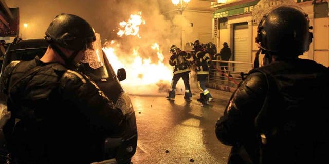 Firefighters try to extinguish a fire during clashes between protesters and police in Corte on the French Mediterranean island of Corsica on February 16, 2016. French club Bastia have "categorically refused" an order by the French Professional League (LFP) to advance the kick-off time of their Ligue 1 game against Nantes on February 20 amid security fears in Corsica. The decision to bring the game forward from 20:00 local time (1900GMT) to 14:00 (1300GMT) was requested by police on the French Mediterranean island after violence sparked by Corsican fans during the league game at Reims on February 13. Fans threw fireworks at police before and after the match in the Champagne region with the violence spilling into the town when a 22-year-old Corsican suffered a serious eye injury while being pursued by police. Fresh clashes erupted on Tuesday when around 50 masked individuals interrupted peaceful demonstrations by throwing Molotov cocktails at police forces, who in turn responded with tear gas to quell the trouble. / AFP / Pascal POCHARD-CASABIANCA (Photo credit should read PASCAL POCHARD-CASABIANCA/AFP/Getty Images)